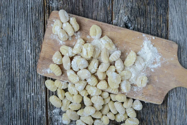 Gnocchi on Cutting Board and Rustic Wood Background — Stock Photo, Image