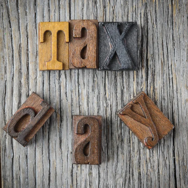 Tax Day Spelled out in Wood Block Letters on Wood Background — Stock Photo, Image