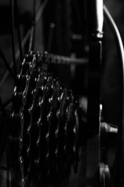 Bicycle details, gear details of gears and chain, dark abstract background, selective focus.