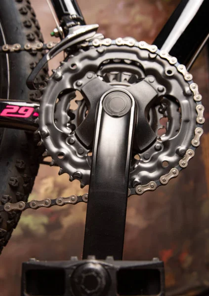 Bicycle details, details of the steering wheel of gears and chain, dark abstract background, selective focus.