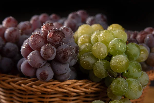 grapes, basket with dewy Brazilian grapes on rustic wood, selective focus.