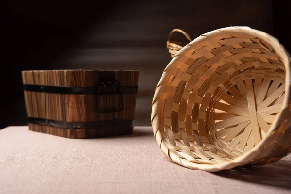 Empty baskets and boxes on a table with beige tablecloth, selective focus.