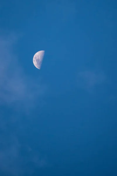 Moon, beautiful moon during the day with blue sky in the background, small depth of field. Selective Focus.