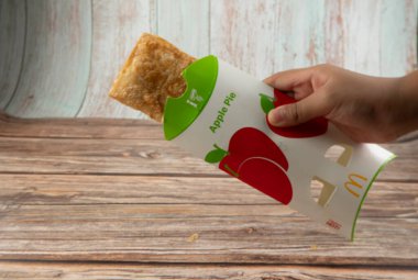 Rawang, Selangor, Malezya, 4 Mart 2021 McDonald 's Elmalı Turtası arka planda ahşap masa ile izole edilmiş. Dışı çıtır çıtır, içi sıcak. Seçici odak