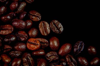 close up roasted espresso coffee beans black background