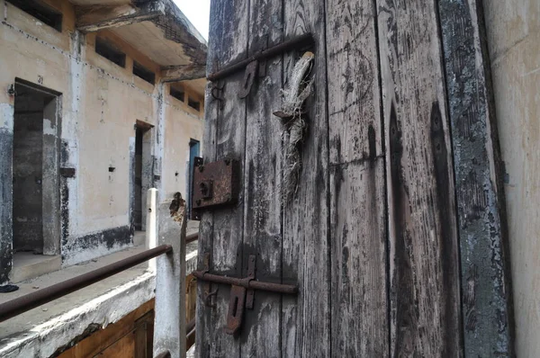 Broken door in an abandoned prison in the former Ussher Fort in Accra, Ghana.
