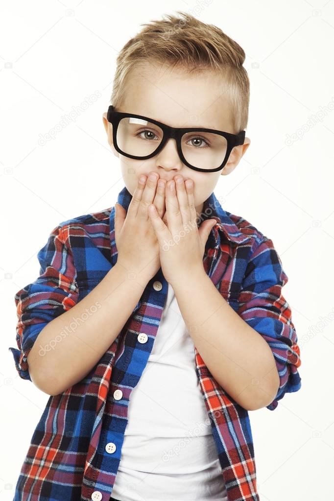 Funny child.fashionable little boy in glasses, jeans, white t-shirt and plaid shirt.stylish kid  in shock and surprise. fashion children