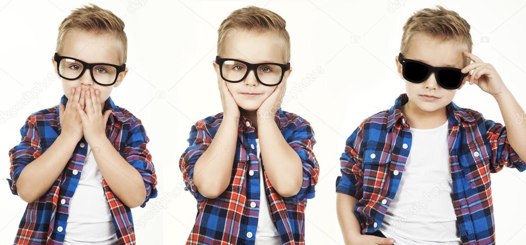 Funny child.fashionable little boy in glasses, jeans, white t-shirt and plaid shirt.stylish kid  in shock and surprise. concept of a fashion children which showed monkey motions: hear nothing, say nothing, see nothing