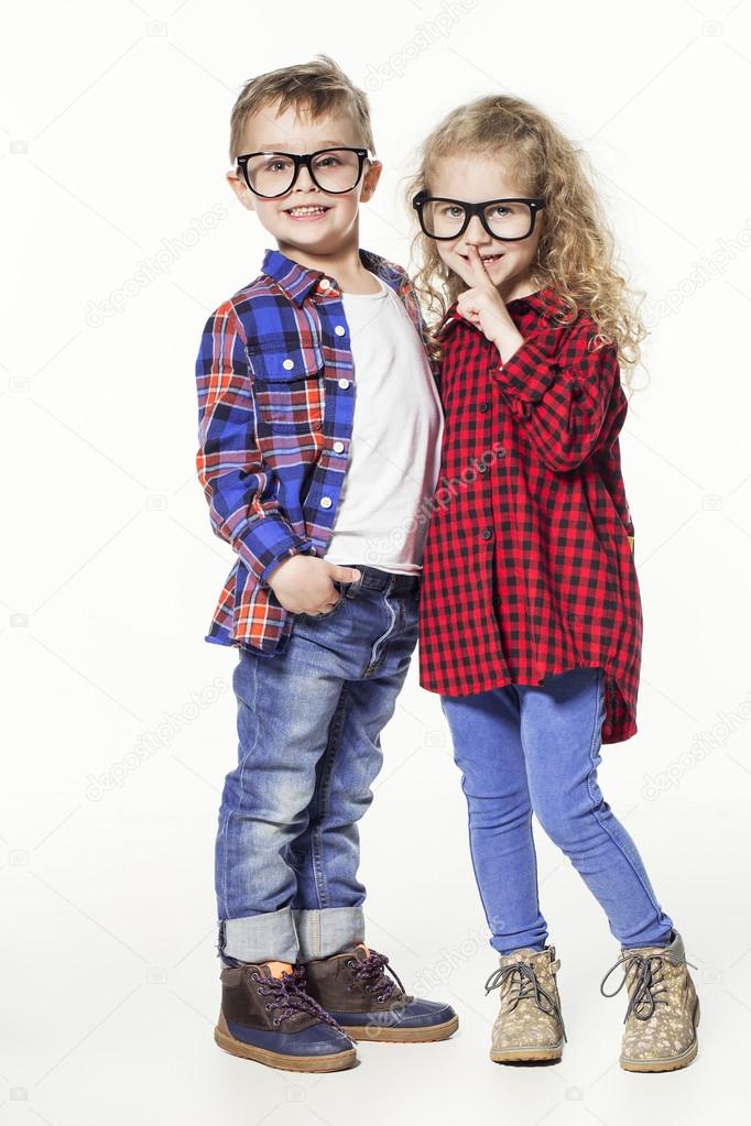 Funny lovely children. fashionable little boy and girl in glasses, jeans, white t-shirts and plaid shirts. stylish kids in casual clothes in fashion children Stock Photo by ©ElaineNadiv 106982254