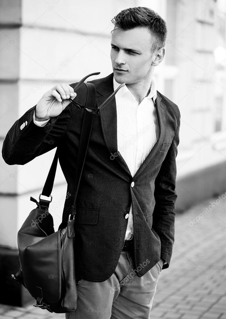 Fashion portrait of a young handsome casual man looking away fro