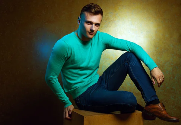 Portrait of handsome stylish man in trendy clothing sitting on c — Stock Photo, Image