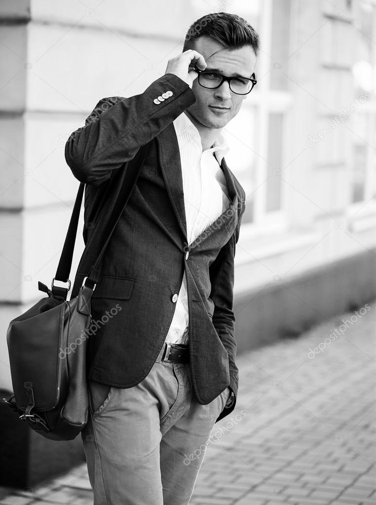Fashion portrait of a young casual man looking  at the camera. Street photo. Stylish clothes