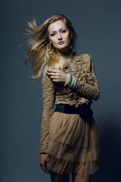 Menina bonita com pele perfeita, cabelo loiro e olhos azuis posando no fundo cinza. Fechar retrato . — Fotografia de Stock