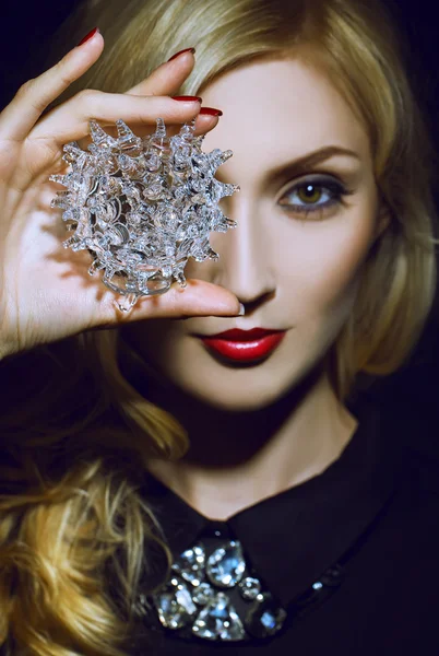 Beautiful Sexy Woman face closeup, makeup with Red Lips and Nails, holding a crystal ball in her hand. — Stock Photo, Image