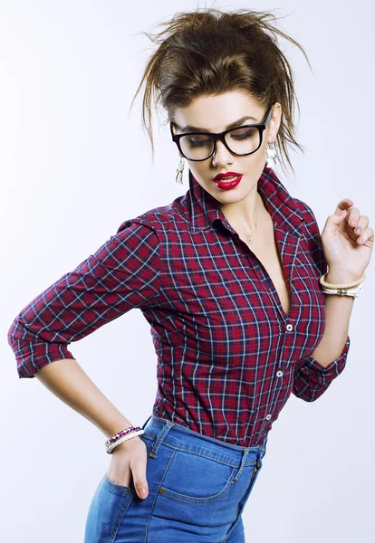 Portrait of fashion sensual pretty crazy fashion brunette with sexy lips in hipster style glasses on white background having fun alone — Stock Photo, Image
