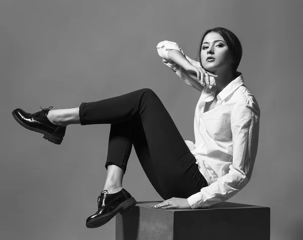 Concept de beauté féminine. Portrait de jeune fille à la mode en vêtements classiques posant sur fond d'or. Cheveux et peau parfaits. Style vogue. Plan studio — Photo