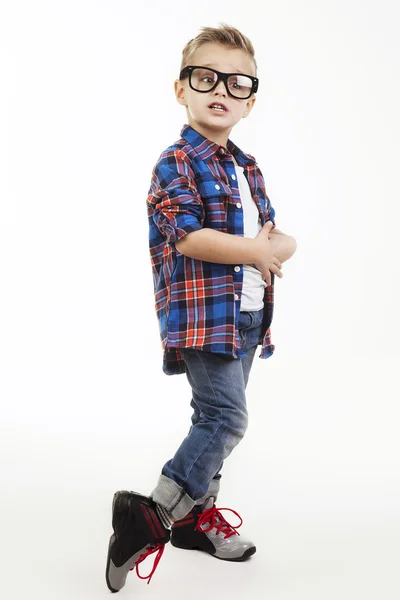 Menino engraçado child.fashionable em óculos, jeans, t-shirt branca e xadrez shirt.stylish miúdo em sapatos desportivos. moda crianças — Fotografia de Stock