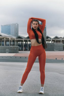 Genç bayan sporcu antrenmandan önce trisepslerini esnetiyor. Beyaz kadın koşudan önce ısınıyor. Aktif yaşam tarzı konsepti. Spor konsepti.