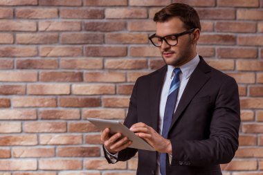 Attractive businessman with gadget