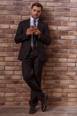 Attractive businessman with gadget