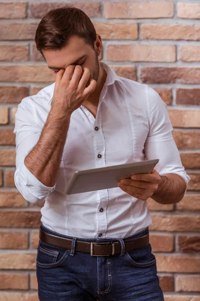 Attractive businessman with gadget — Stock fotografie