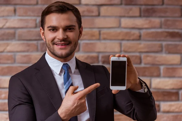 Attractive businessman with gadget — Stok fotoğraf