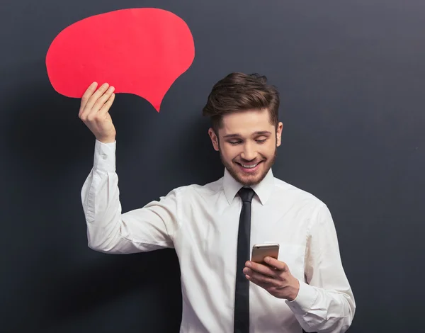 Handsome student with speech bubble — Stock Photo, Image