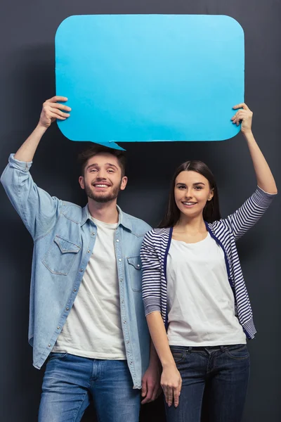 Young couple with speech bubbles — Stock Photo, Image