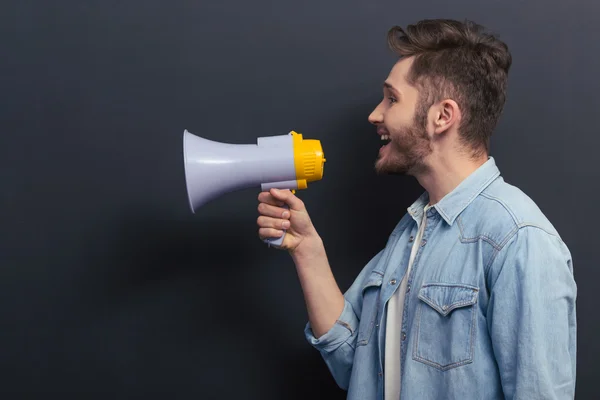 Young man with loudspeaker — Stockfoto