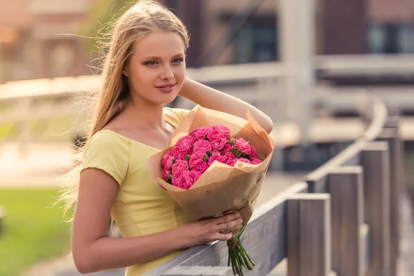 Attractive girl with flowers — Stock Photo, Image