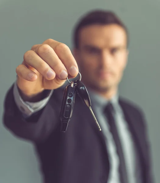 Handsome businessman with keys — Stock Photo, Image