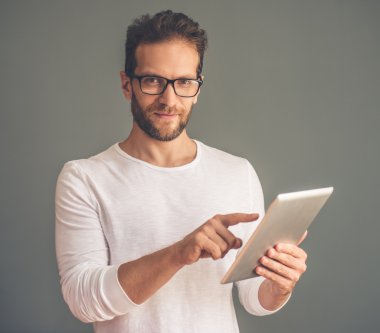 Handsome young man with gadget