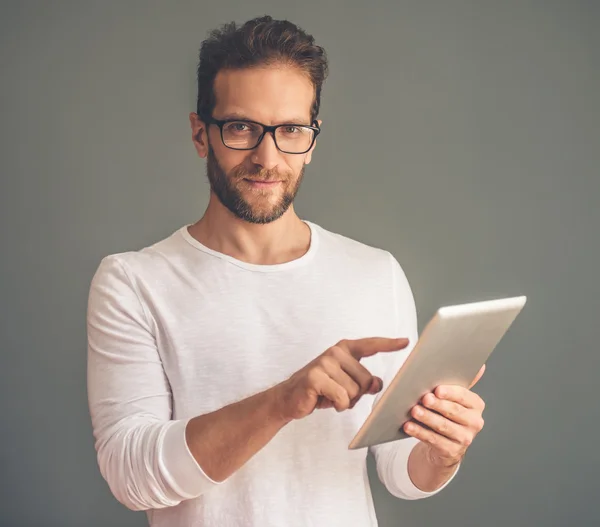 Handsome young man with gadget — Stockfoto