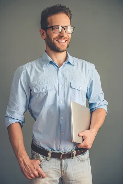 Handsome young man with gadget — Stockfoto