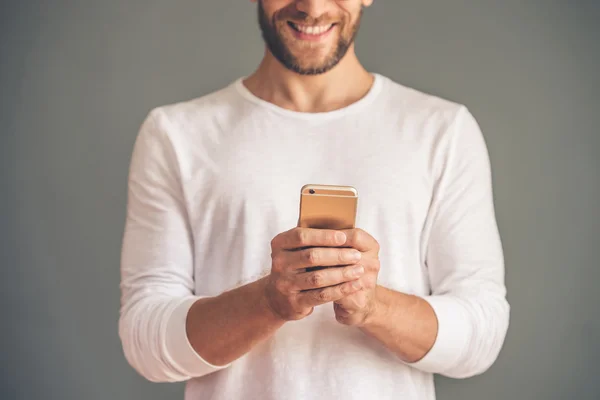 Handsome young man with gadget — Stock Photo, Image