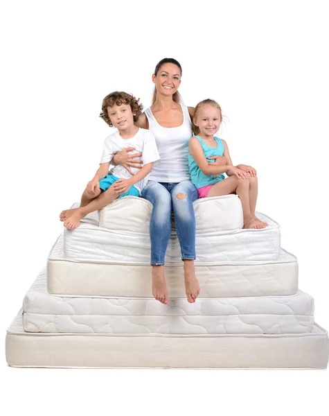Family and many mattresses — Stock Photo, Image