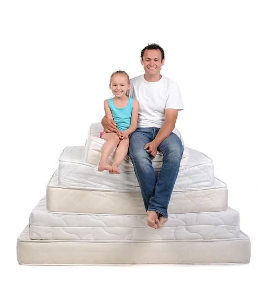 Family and many mattresses — Stock Photo, Image