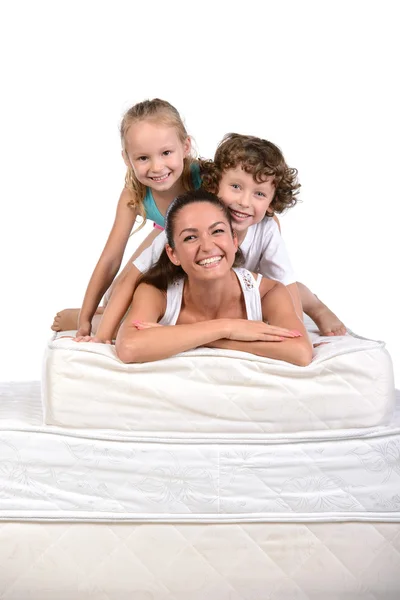 Family and many mattresses — Stock Photo, Image