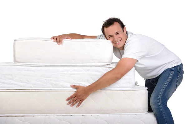 Family and many mattresses — Stock Photo, Image