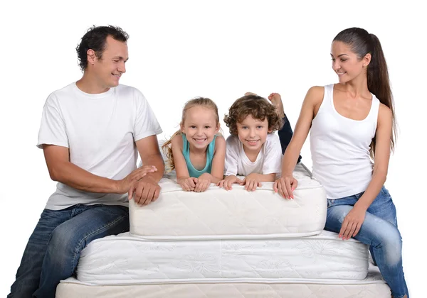 Family and many mattresses — Stock Photo, Image