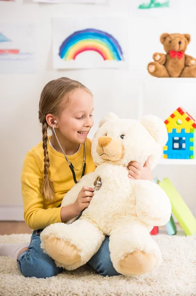 Girl playing with teddy bear — Stock Photo, Image