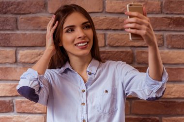 Beautiful girl posing with gadget