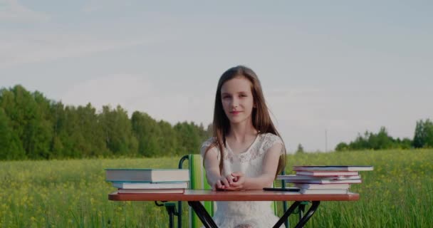 Schoolgirl at desk surrounded by nature. Back to school and Beginning of school year — Stock Video