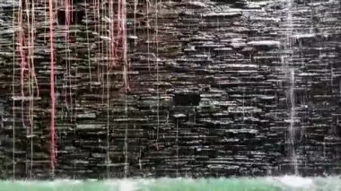 Water runs down gray stones