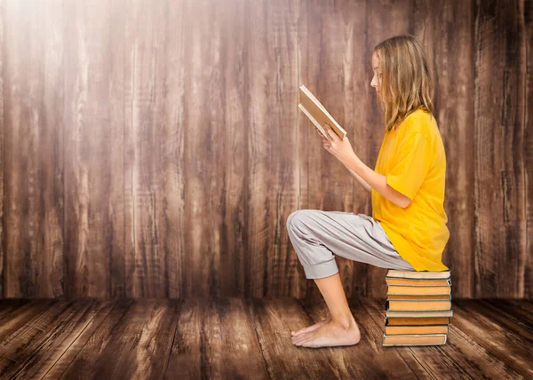 Child Reads Textbook Sits Stack Books Wooden Background — Stock Photo, Image