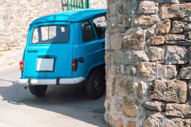 Adriyatik 'in Piran şehrinde Stone Caddesi' ne park edilmiş klasik mavi bir araba.