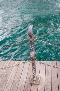 Moody Close-up of Dock Railing with Turquoise Sea Water.