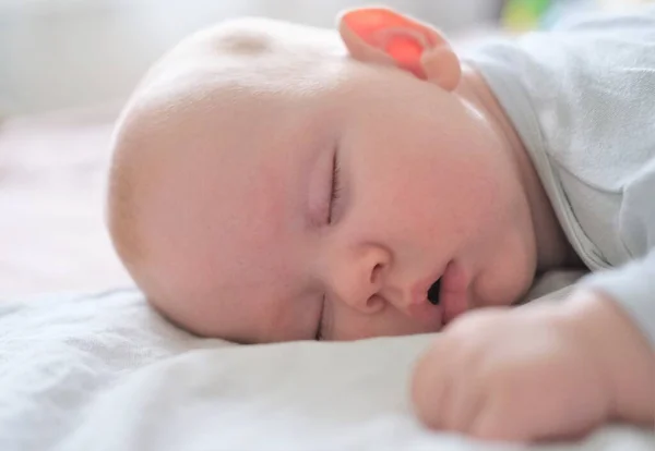 Retrato de un bebé recién nacido durmiendo sobre una manta blanca. —  Fotos de Stock