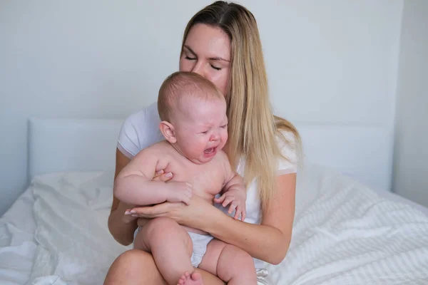 Young Mother Holding Her Baby Her Arms Baby Crying His — Stock Photo, Image