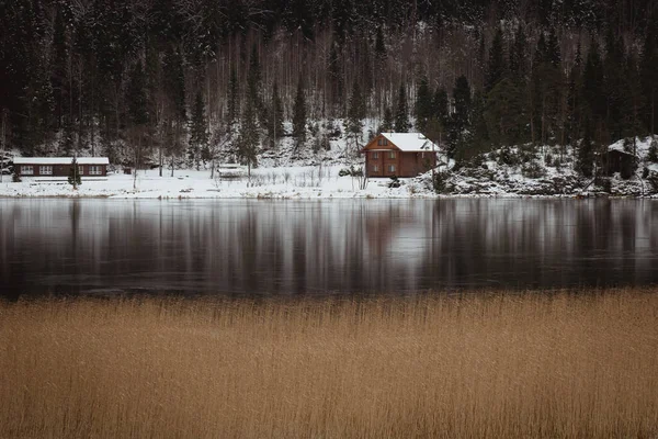 Little house on the shore of a winter lake